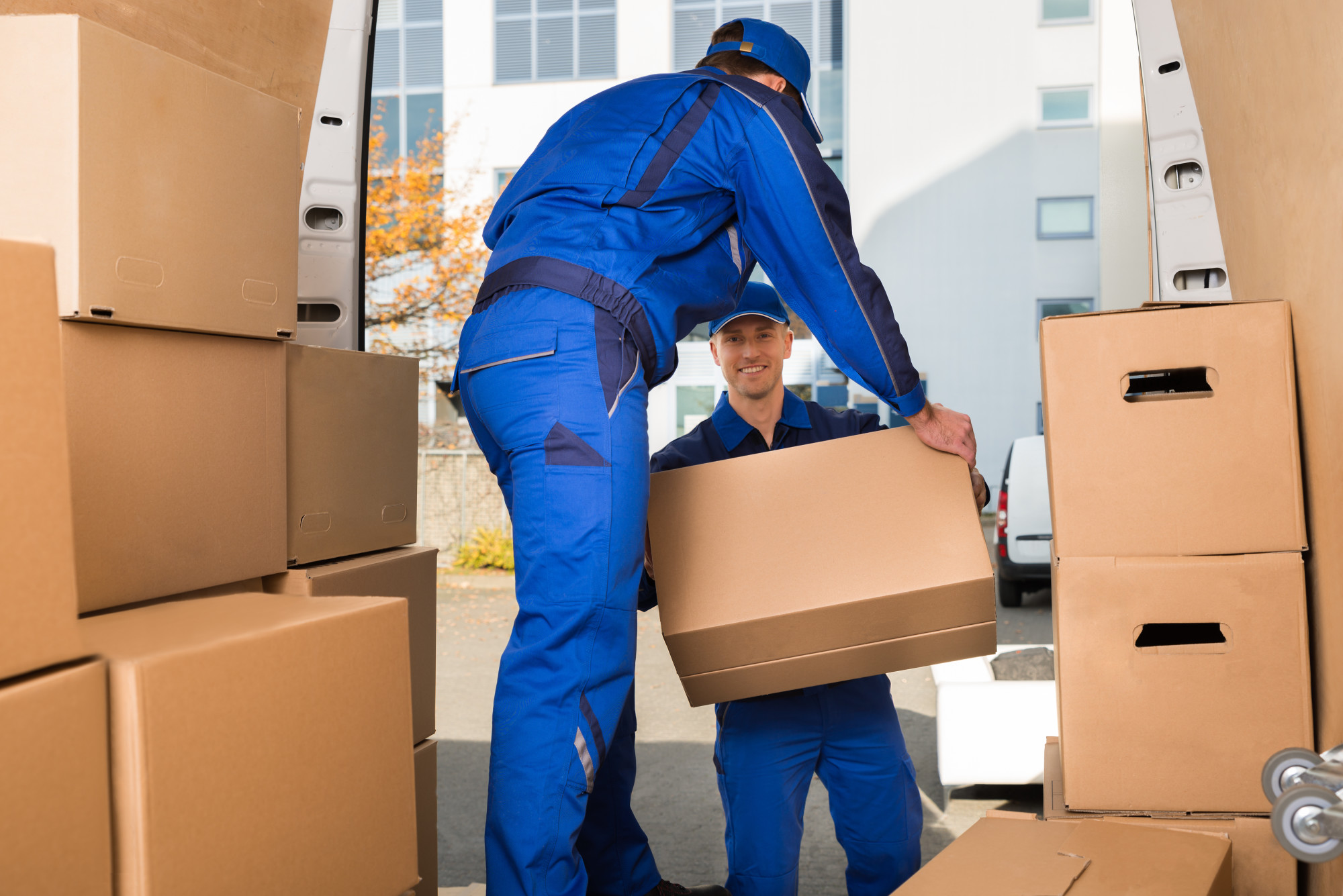 Professional moving equipment, protective blankets, packing cartons, and relocation supplies prepared for a move